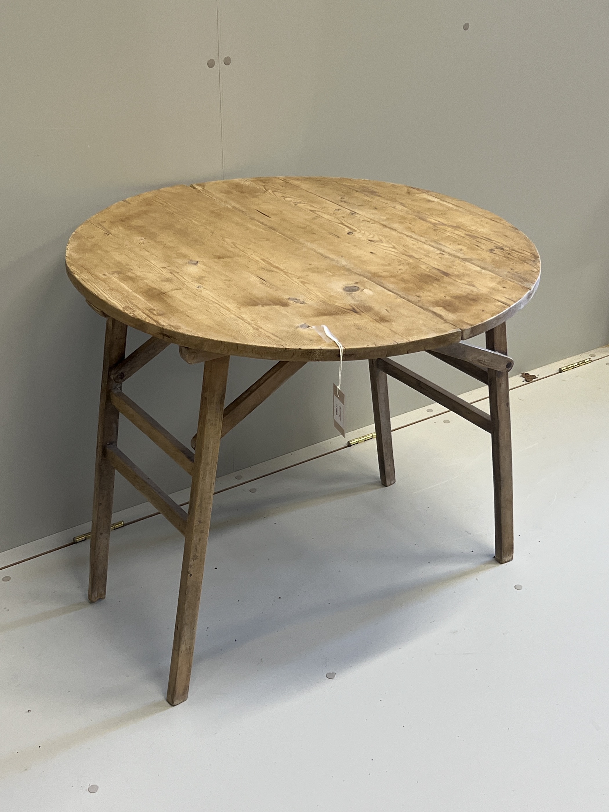 A 19th century French circular pine folding occasional table, diameter 75cm, height 68cm